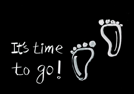 It is time to go! hand writing footprints and words on blackboard