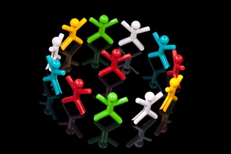 Team work concept. Colorful dolls on black background.の写真素材