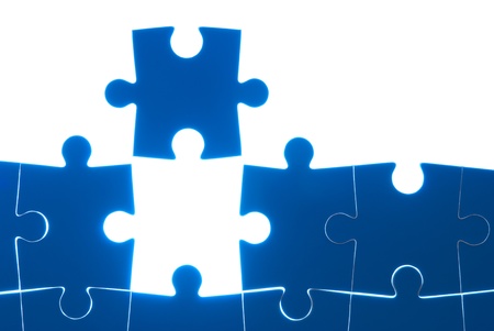Puzzle blue isolated on white background with back lightの写真素材