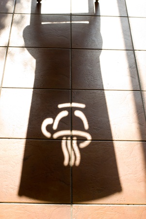 Shadow of coffee logo on the red brick floorの写真素材