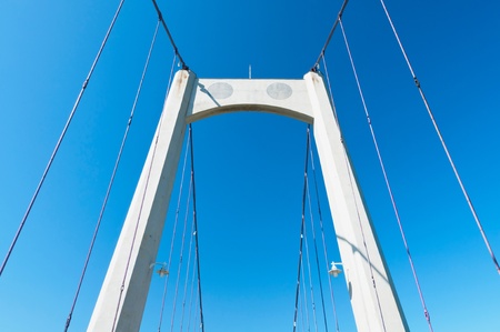 Steel ropes of suspending bridge with pure blue sky backgroundの写真素材