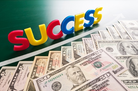 Colorful success words and growing US dollars on blackboardの写真素材
