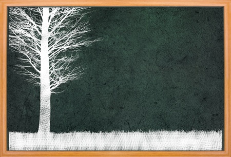 Single tree on grass land drawing on retro blackboardの写真素材