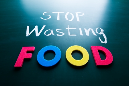 Stop wasting food concept, colorful words on blackboardの写真素材