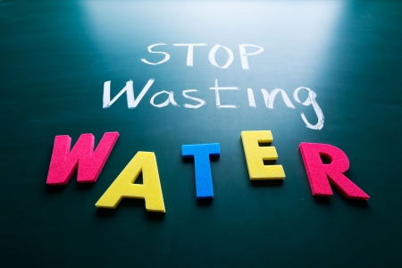 Stop wasting water concept, colorful words on blackboardの写真素材