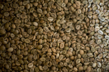 A pile of green coffee beansの写真素材