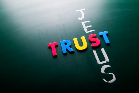 Trust Jesus concept, words on blackboard
