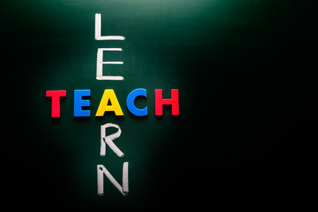 Learn and teach concept, words on blackboardの写真素材