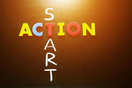 Colorful word action and writing word start crossing on blackboardの写真素材