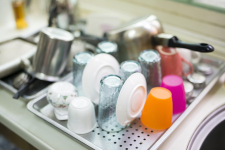 Cups and plates drying on metallic plateの写真素材