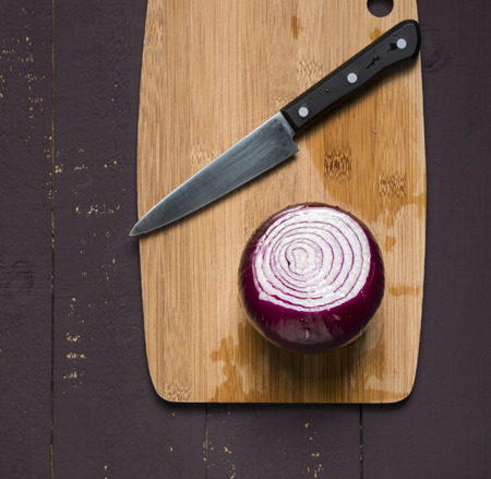 Fresh cut red onion for cooking on wooden board.の写真素材