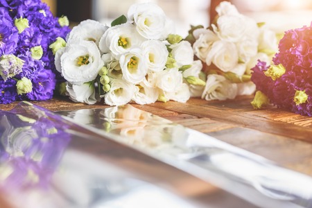 Purple and white flowers on table with reflection