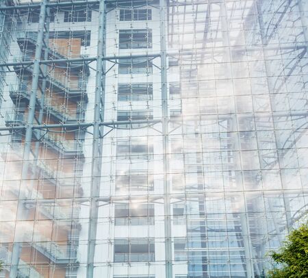 Architectural background of a modern high-rise building with a clear glass facade