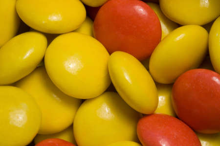 A close up of red & yellow colored sugar sweets