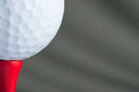 White golf ball on red golf teeの写真素材