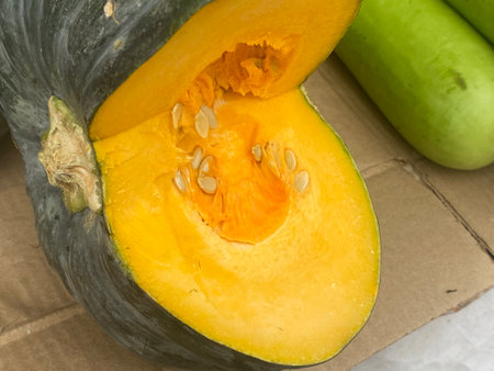 Pumpkin and zucchini in a paper box on the tableの写真素材