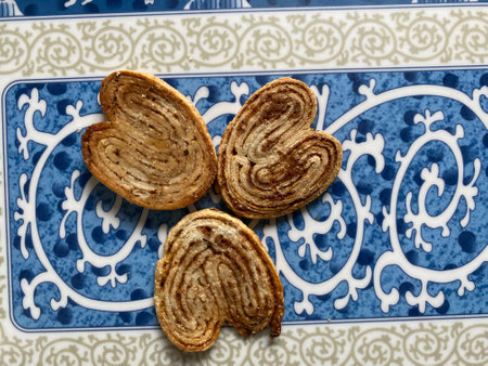 Crispy cookies in the shape of a heart on a blue plateの写真素材
