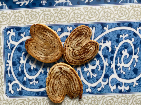 Crispy cookies in the shape of a heart on a blue plateの写真素材