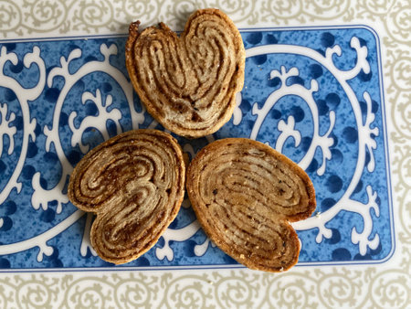 Chocolate cookies in the shape of a heart on a blue plateの写真素材