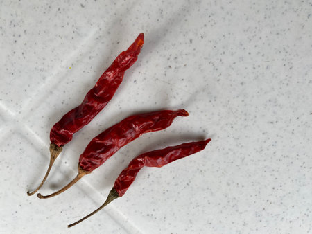 Dried red hot chili peppers on a white background. Copy space.