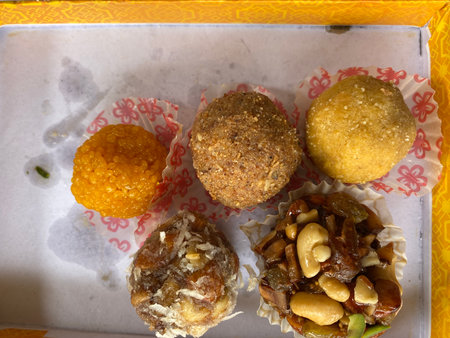 Indian sweets with nuts and raisins in a box on a tableの写真素材