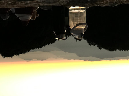 Interior view of a cave, reflected in the water at sunsetの写真素材