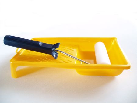 The platen for painting by a paint in a tray of yellow colour.の写真素材
