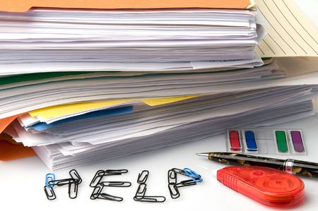 A huge stack of paperwork and files all needing signaturesの写真素材