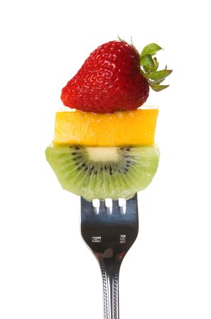 Fresh strawberry, mango slice, and kiwi on a forkの写真素材