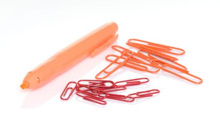 Orange highlighter pen with orange and red paper clips