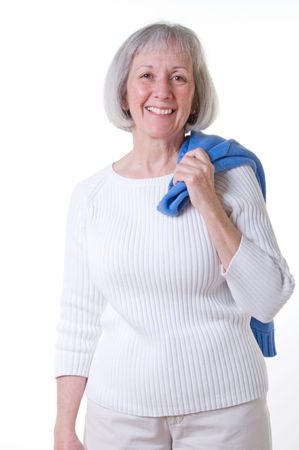 Smiling senior lady wearing a casual white sweater and stone colored chinosの写真素材