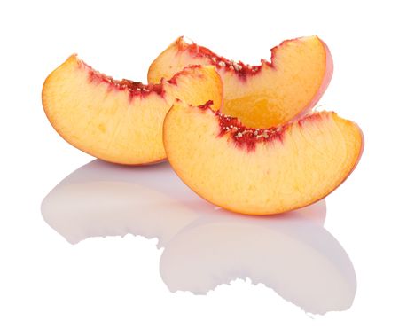 Juicy slices of peach showing beautiful yellow and red colorsの写真素材