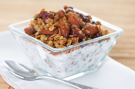 Glass bowl of organic granola with milkの写真素材