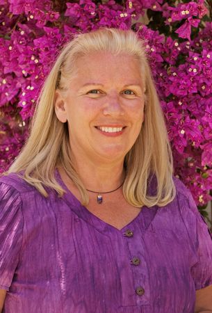 Senior woman enjoying bouganvillea flowers and sunshineの写真素材