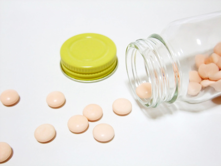 Tablets falling from a bottleの写真素材