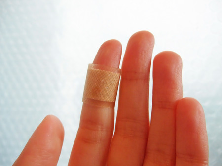 A finger with an adhesive bandage