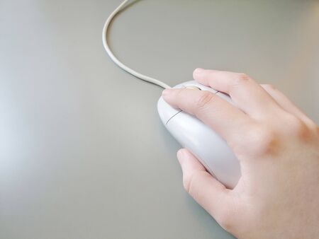 Hand operating a computer mouse