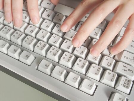 Hand typing on computer keyboard
