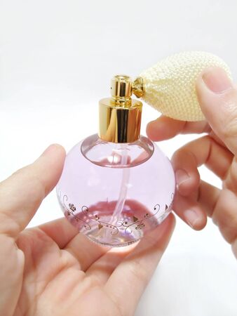 Spray-type perfume bottle in hand