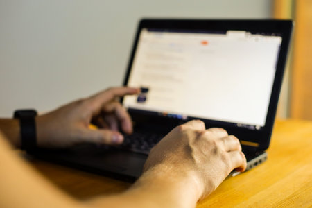 Close-up of man's hand using laptop and credit card for online shoppingの写真素材