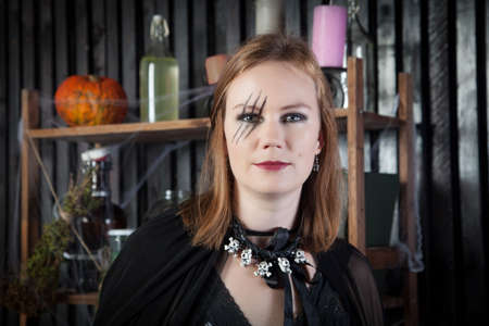 Portrait of young beautiful witch at Halloween