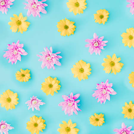 Arrangement pink and white flowers on blue pastel background. Flat lay pattern.の写真素材