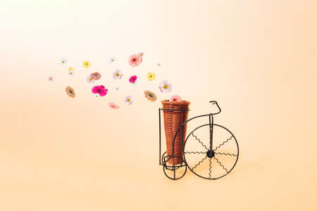 Old classic black bicycles with a basket from which flowers come out.の写真素材