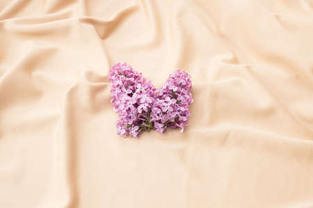 Purple lilac on beige textile. Minimal pattern.
