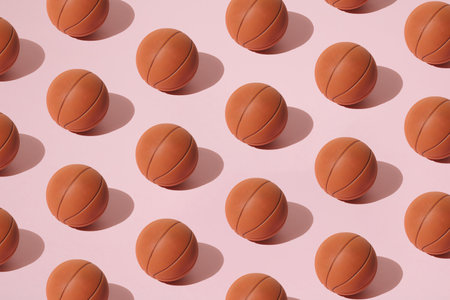 Arranged basketball on a pink background. Minimal design. Pattern.