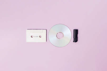 White radio cassette for cassette player and cd and black usb flash memory on a purple backgroundの写真素材