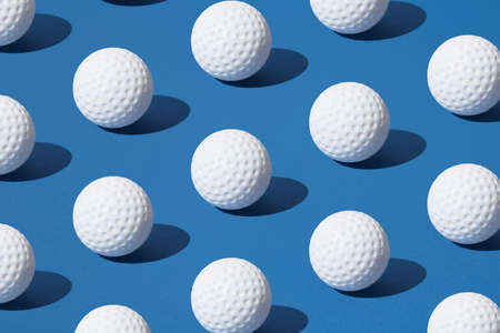 Arranged white golf ball on blue pastel background. Minimal design.の写真素材