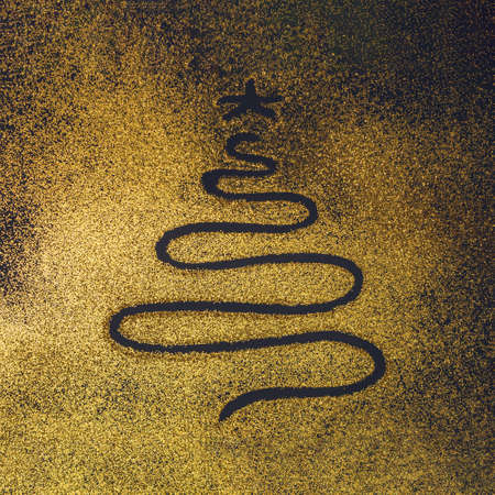 New year tree drawn on a yellow gold glitter black pastel background. Christmas scene, Minimal concept.の写真素材