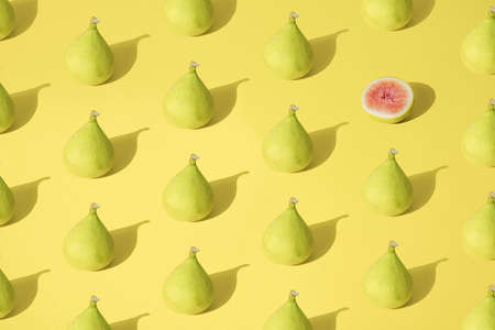 Arranged yellow fig on pastel background. Minimal design. Pattern.の写真素材