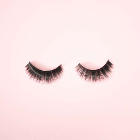 Two lashes on a pink background. Minimal make up design.の写真素材
